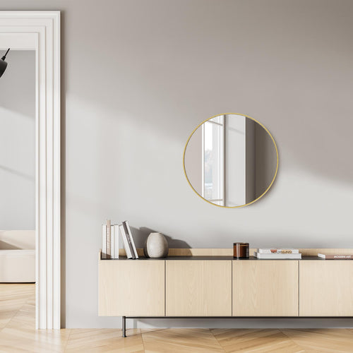20-inch round gold-framed wall mirror above a light wood console