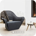 Curved charcoal gray textured woven Nordic lounge chair in an airy minimalist room