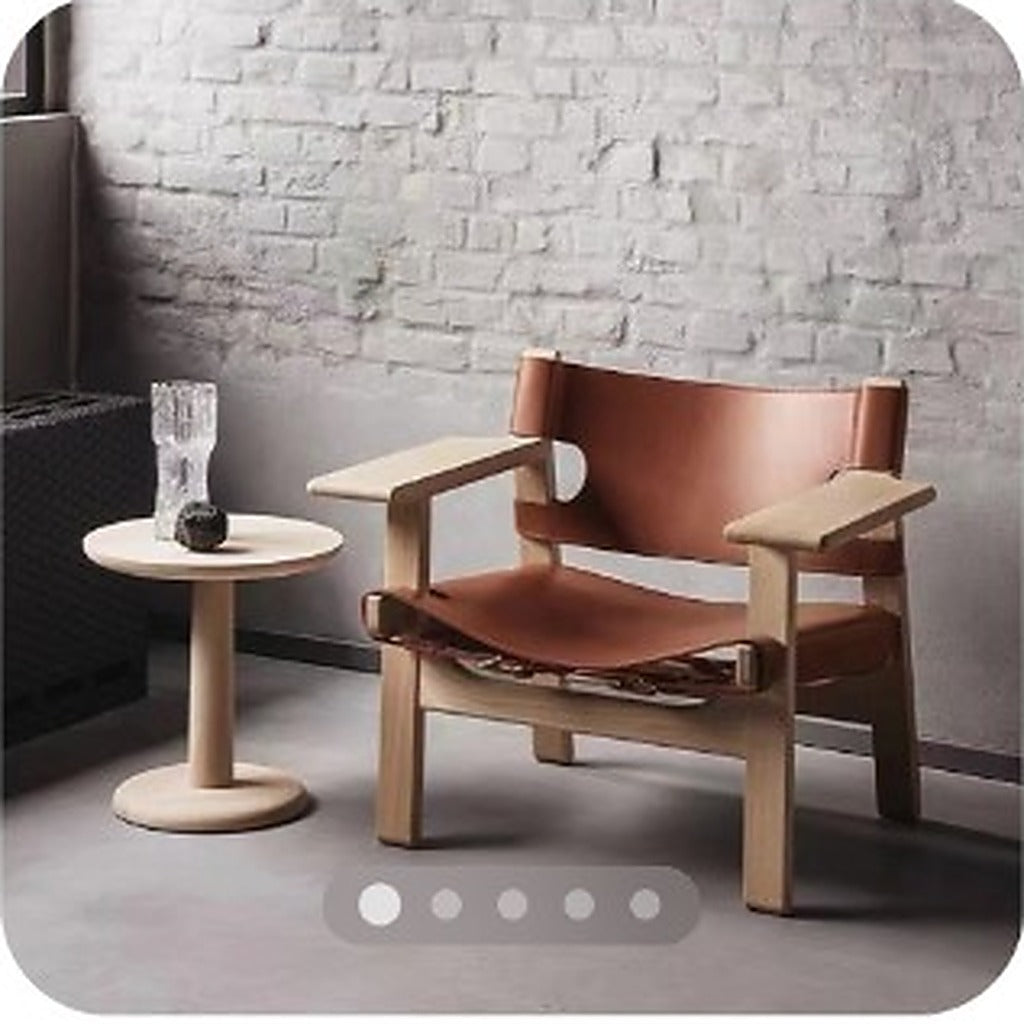 Spanish vintage-style wooden chair with brown leather seat in a muted modern living room